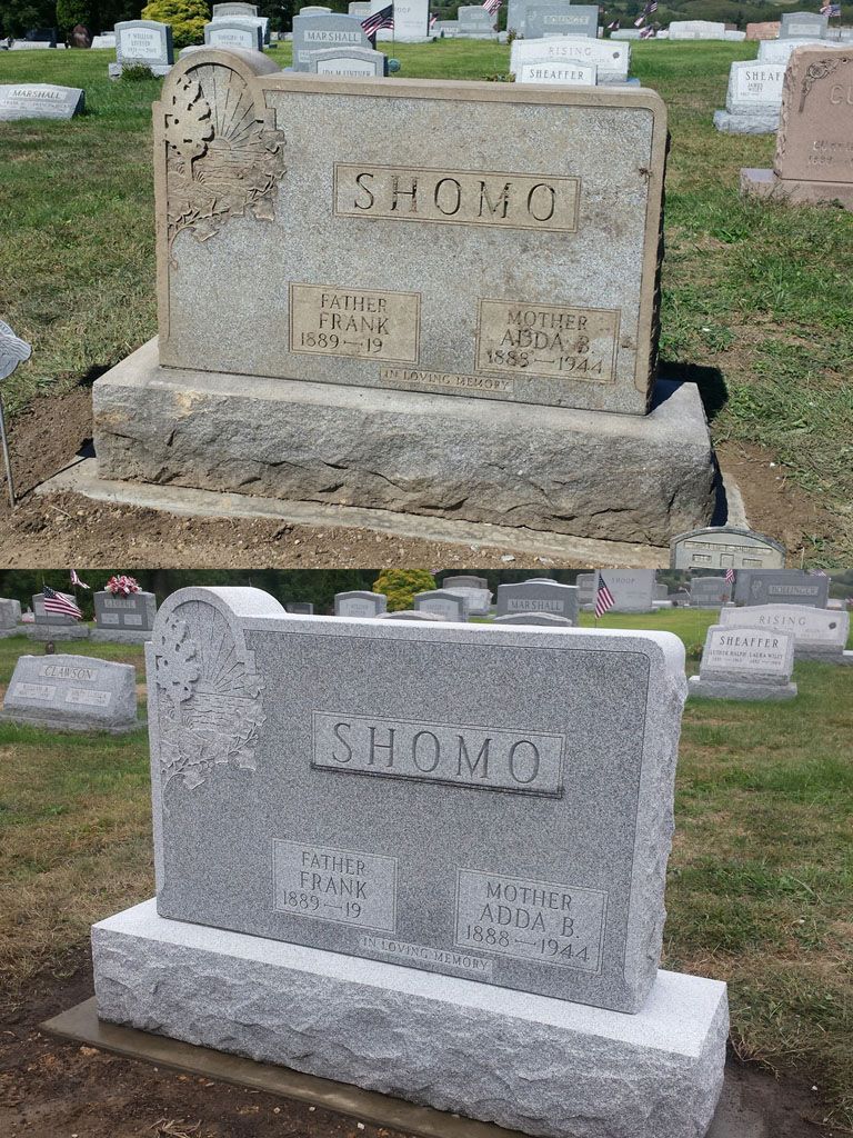 Two gravestones engraved “SHOMO,” one tan and one white, in a cemetery with other headstones nearby