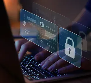 A person is typing on a laptop computer with a padlock on the screen.
