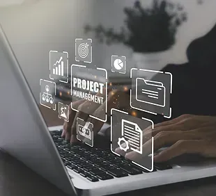 A person is typing on a laptop computer with project management icons coming out of the screen.