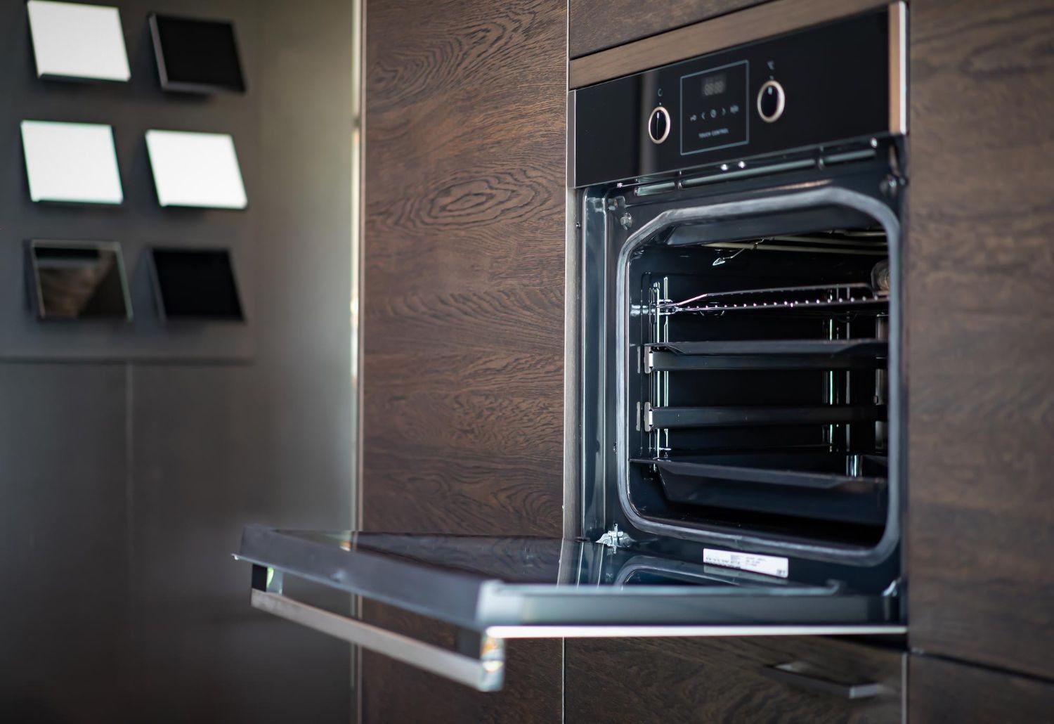 A Person Is Cleaning The Inside Of An Oven With A Towel
