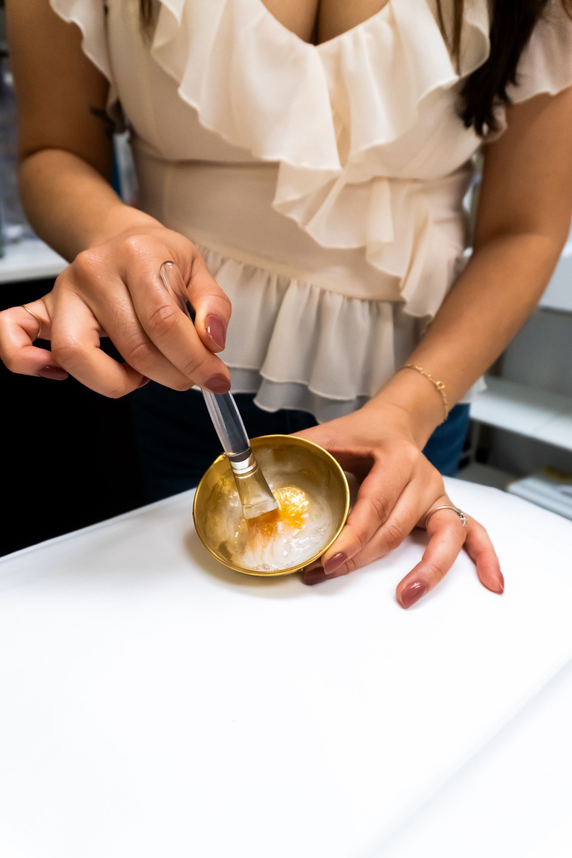 A woman is holding facial treatment