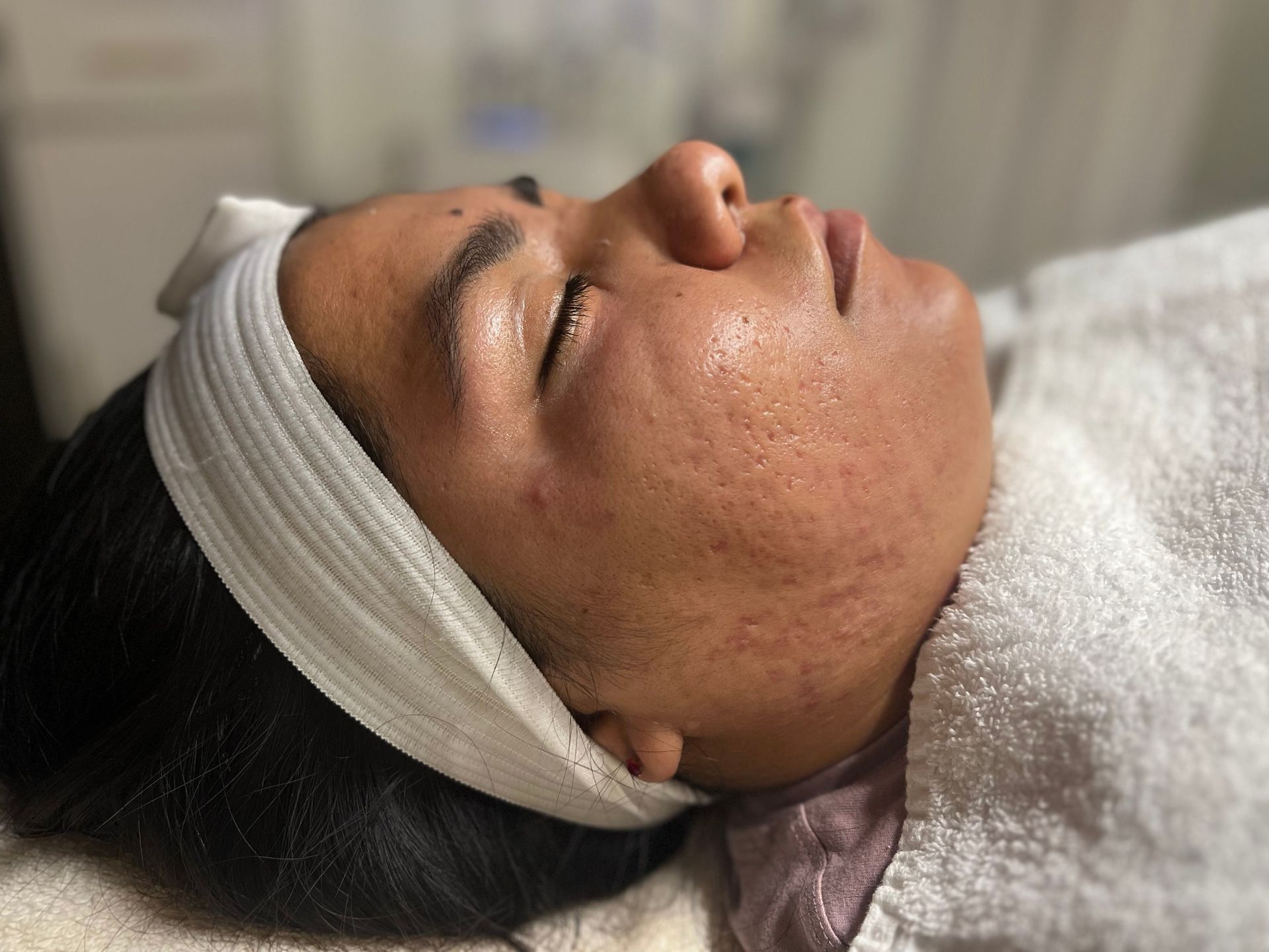A woman is laying on a bed with a headband on her head.