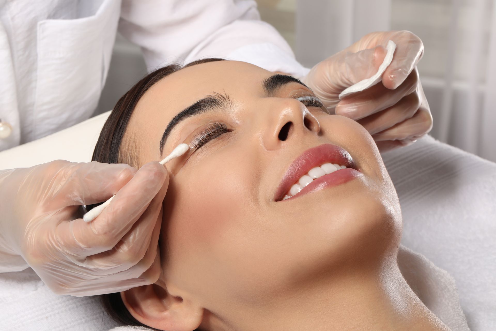 A woman is getting her lash treatment at a beauty salon.