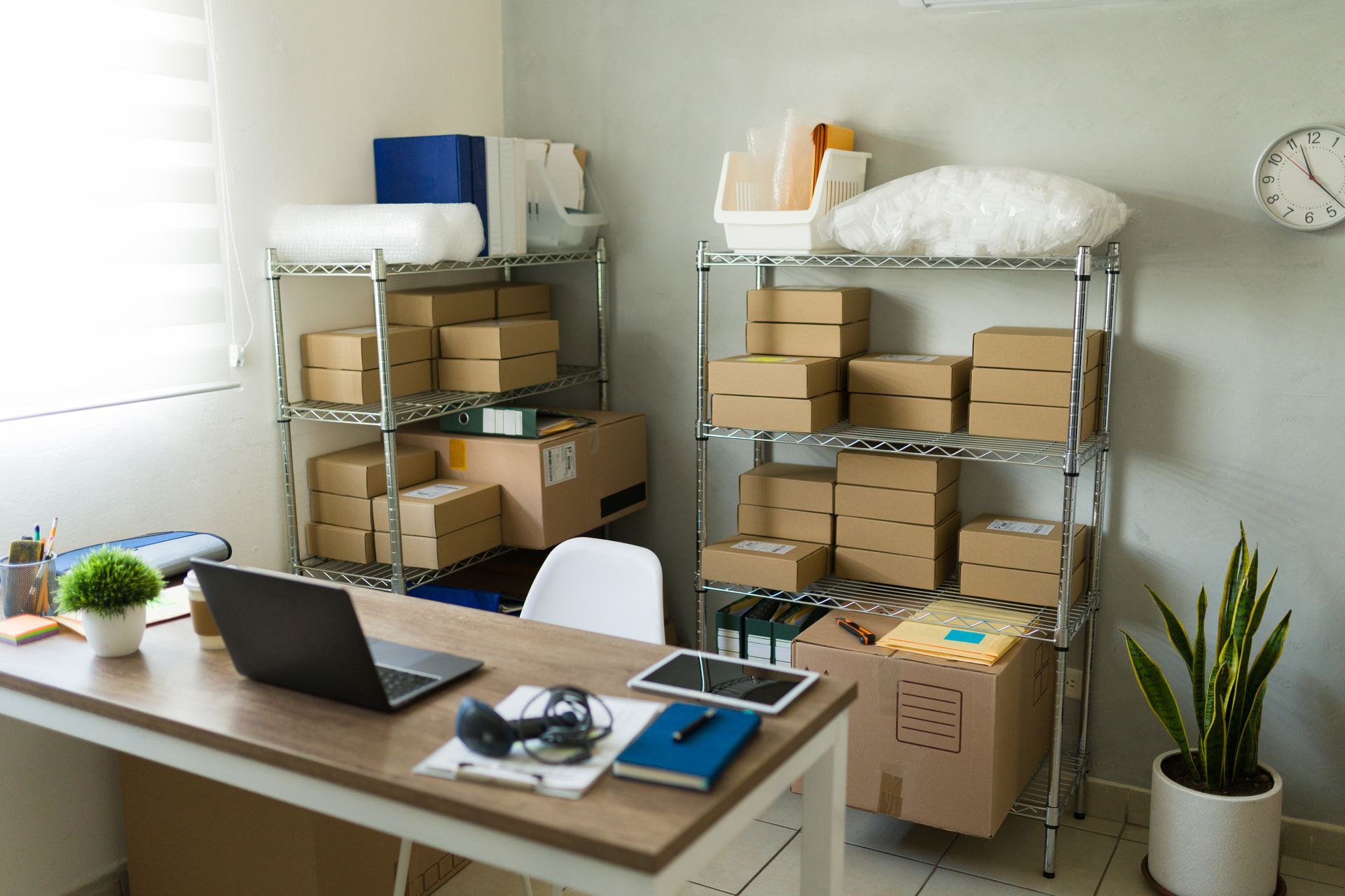 Boxes of office products organized on shelves in a storage room.
