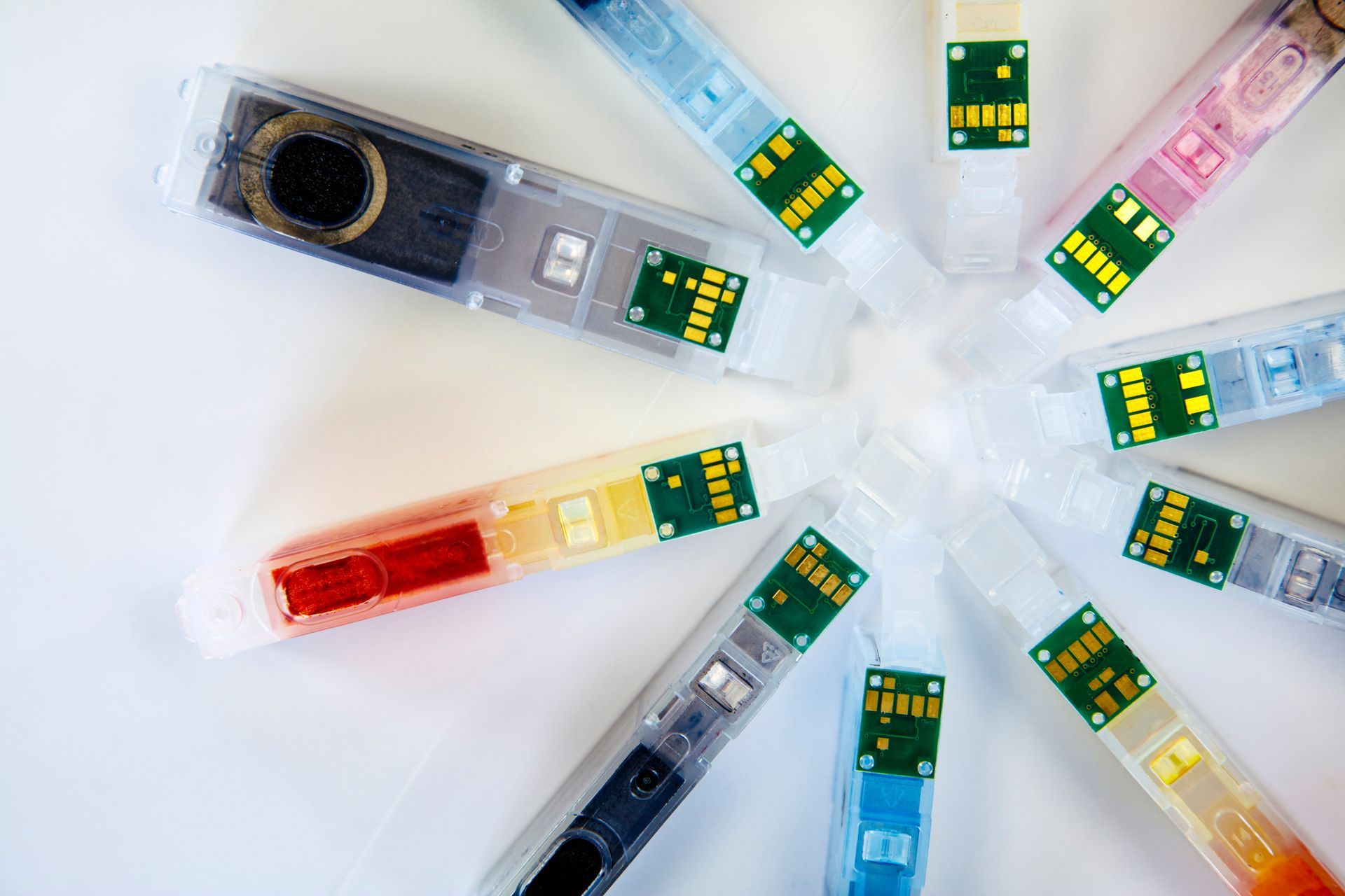 Set of colorful ink cartridges arranged in a circle, showcasing a vibrant spectrum of colors. Set of colorful ink cartridges arranged in a circle, showcasing a vibrant spectrum of colors.