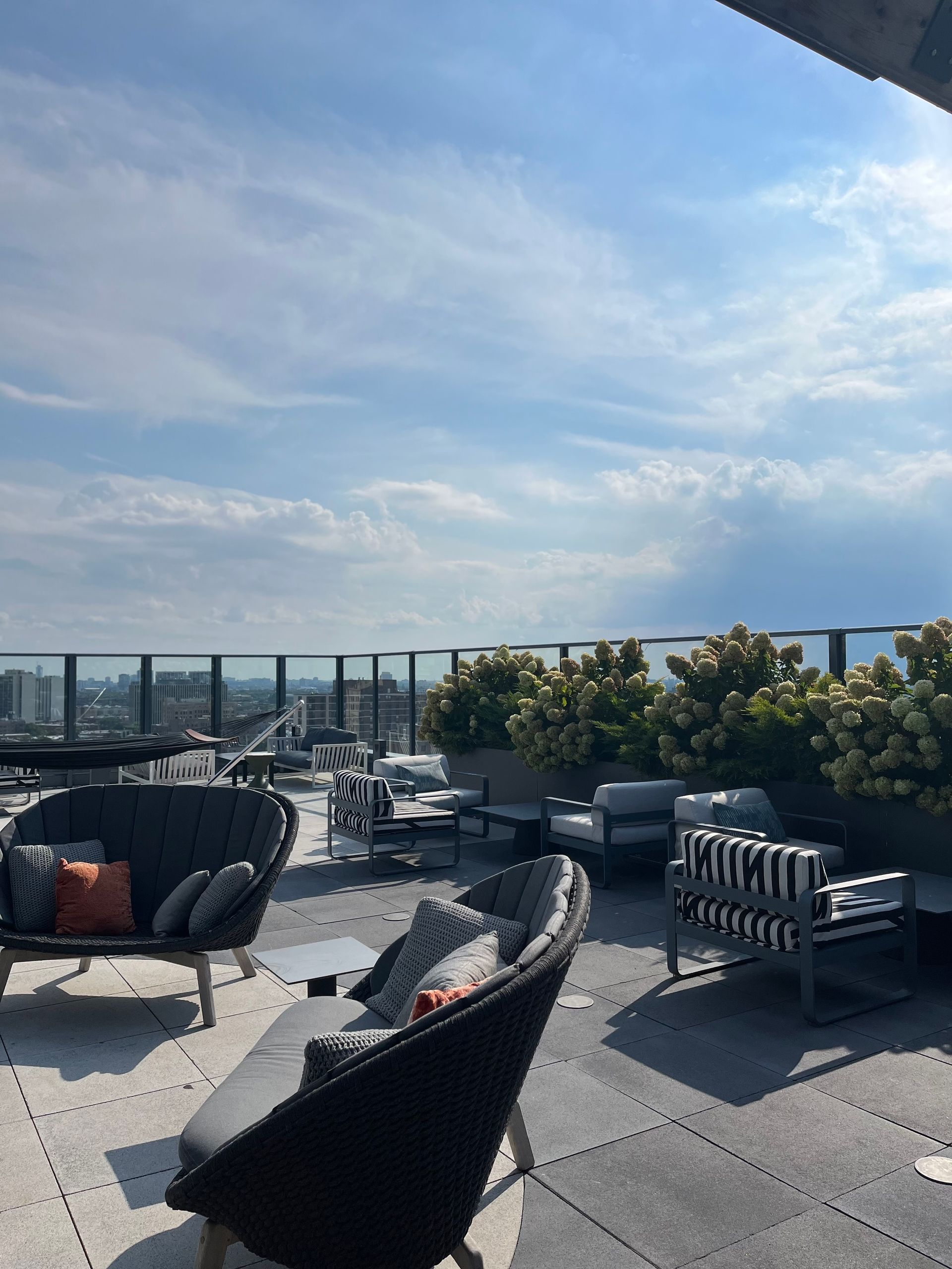 A patio with chairs and a couch on a sunny day