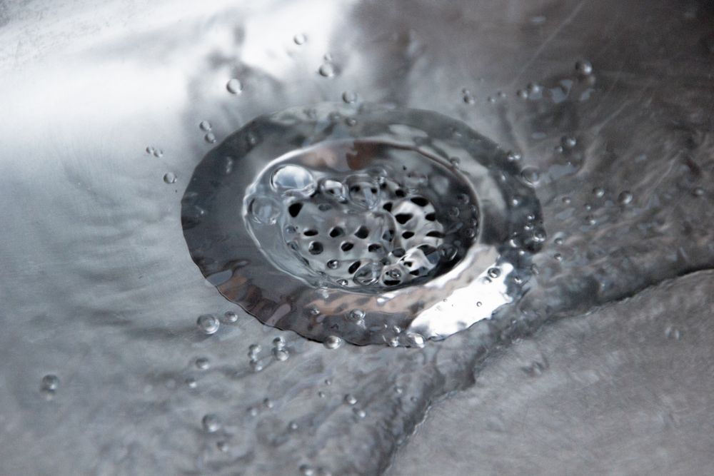 Water Flowing Into a Stainless Steel Sink Drain — Full On Plumbing & Gas in Winnellie, NT