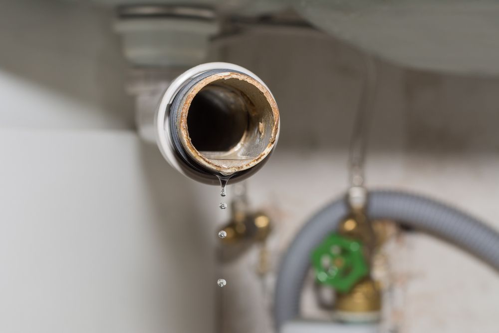 Leaking Pipe Under a Sink, Water Droplets Falling — Full On Plumbing & Gas in Winnellie, NT