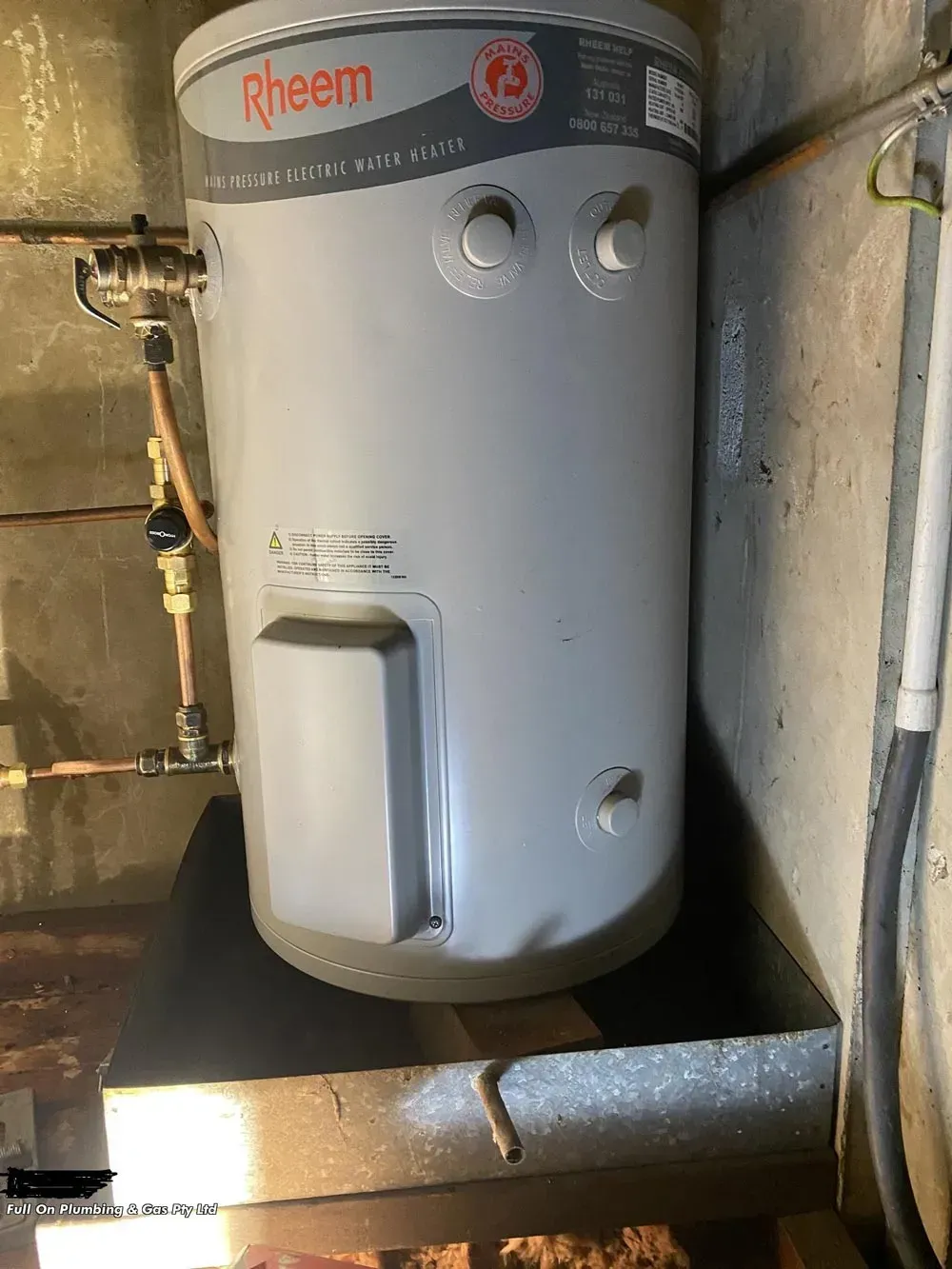 Rheem Water Heater on a Wooden Platform in a Utility Room — Full On Plumbing & Gas in Winnellie, NT