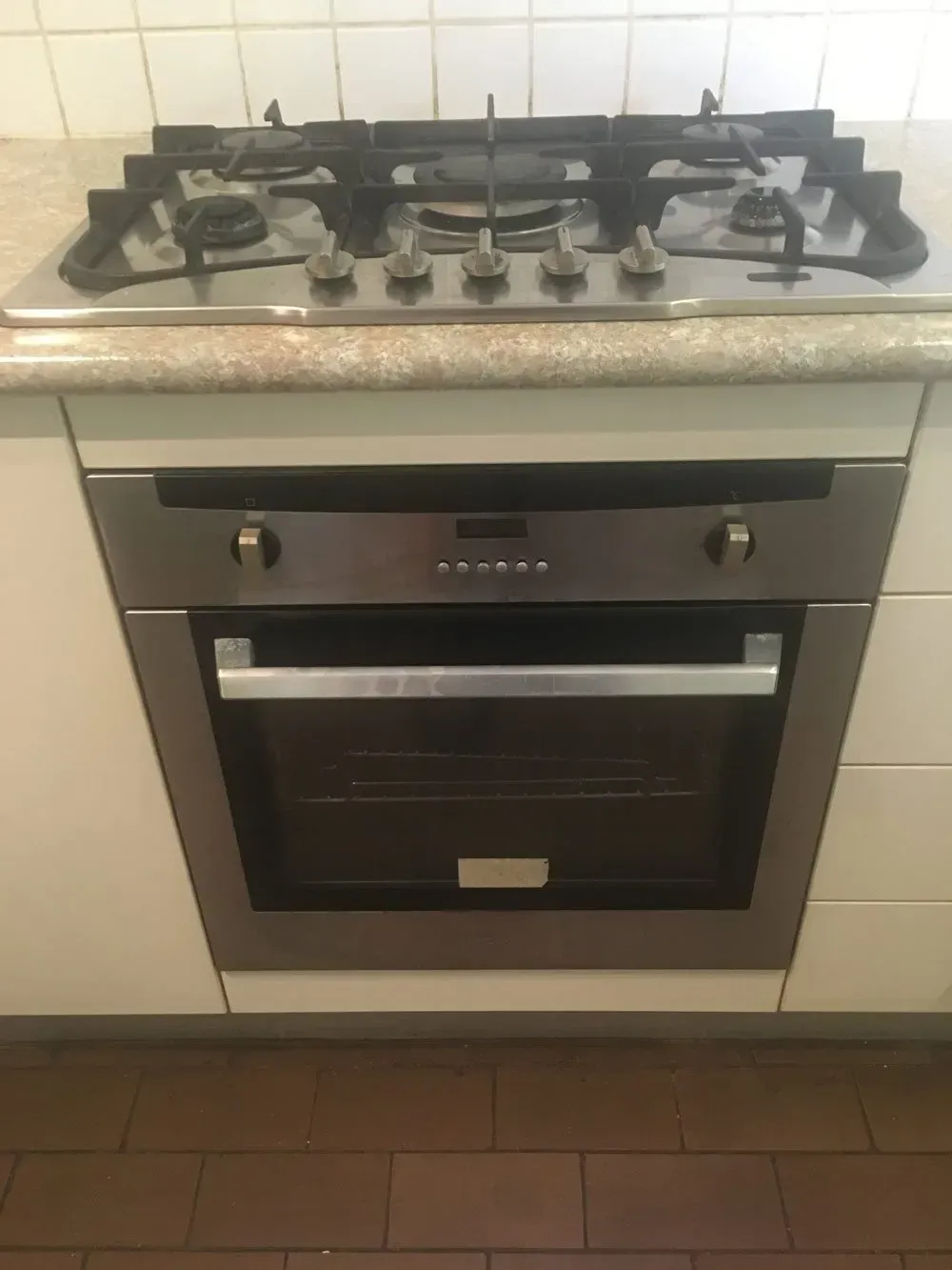 Stainless Steel Oven and Gas Cooktop Built Into White Cabinetry — Full On Plumbing & Gas in Winnellie, NT