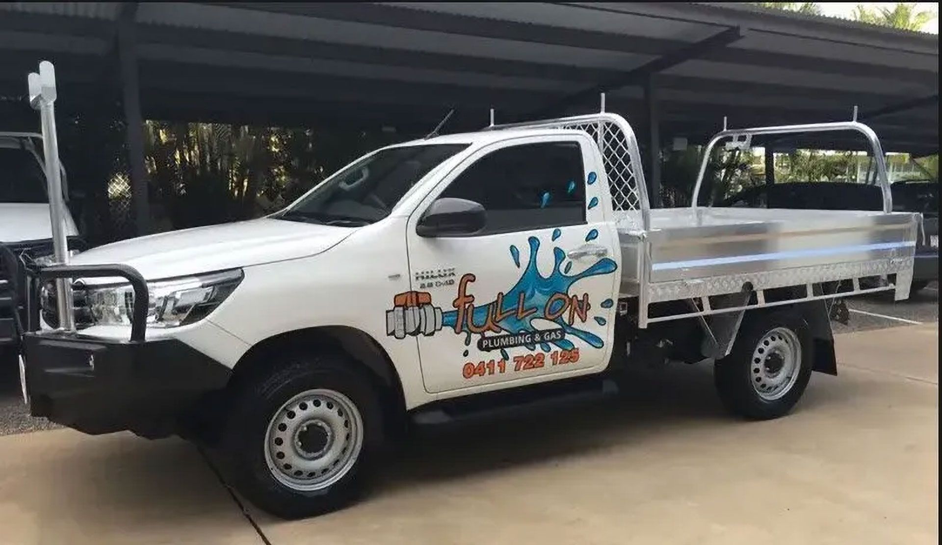 White Pickup Truck With a Flatbed and Company Logo, Parked Under a Carport — Full On Plumbing & Gas in Winnellie, NT