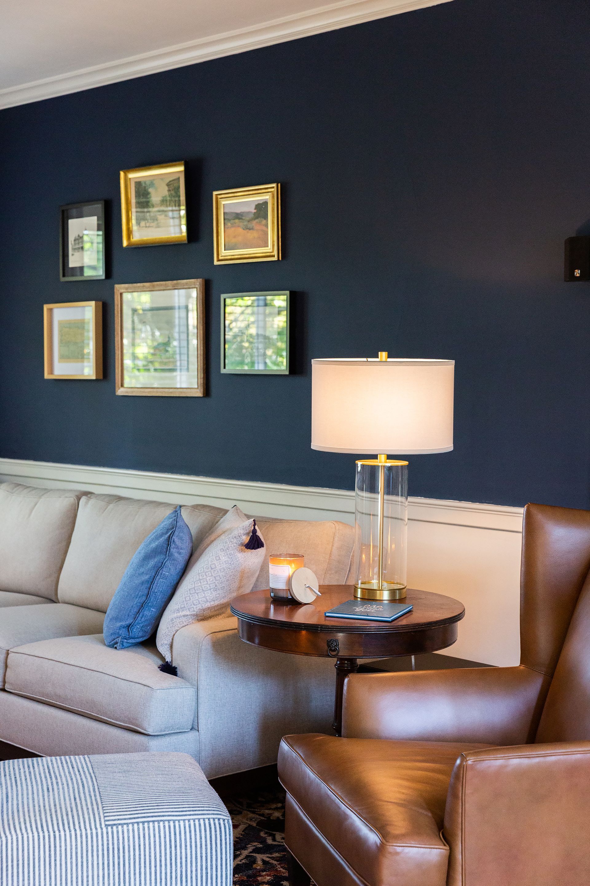 A living room with a couch a chair and a lamp