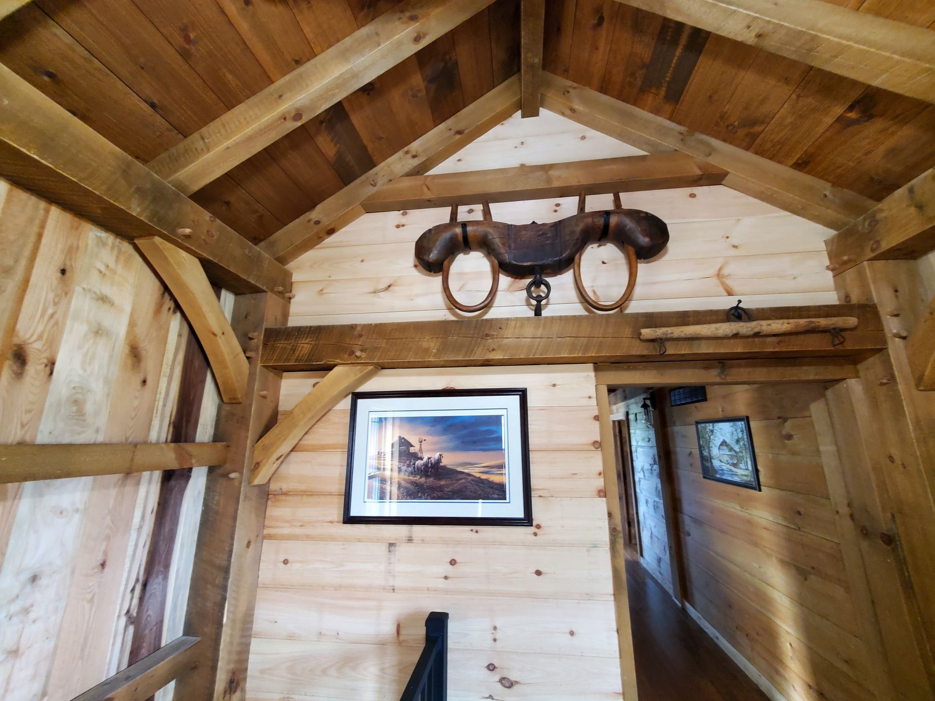 Wooden interior with saddle decor and framed art on the wall.