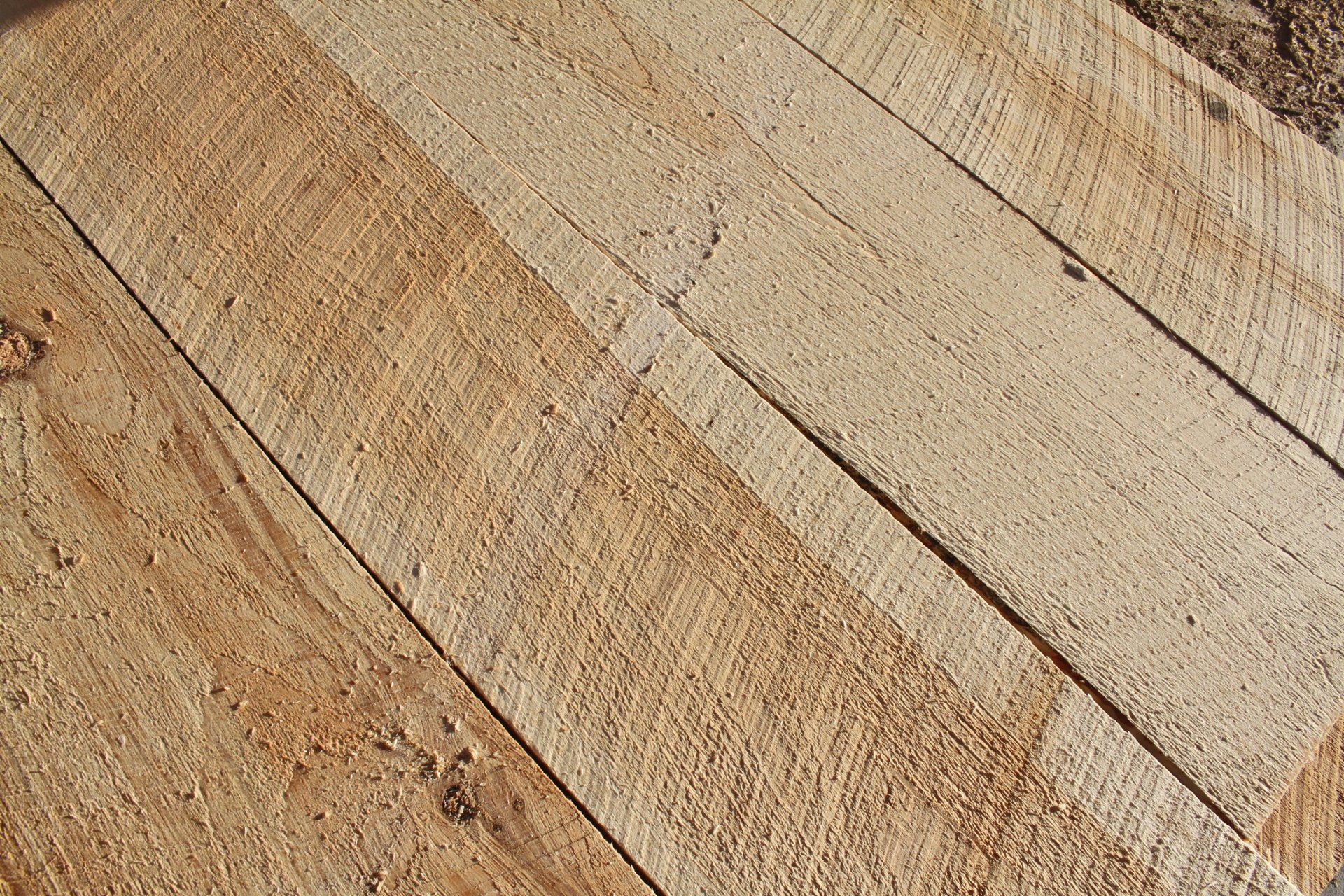 Close-up of diagonally placed unfinished wooden planks.