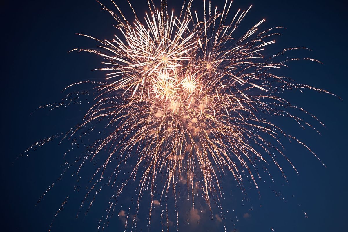 A fireworks display against a dark blue sky