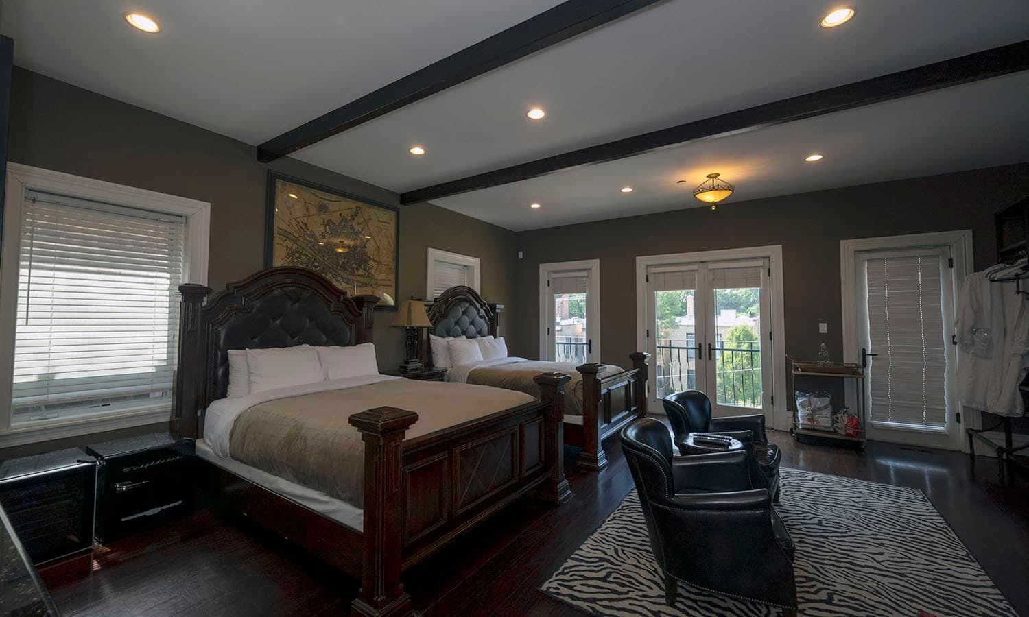 A large bedroom with two beds , a living room , and a balcony.