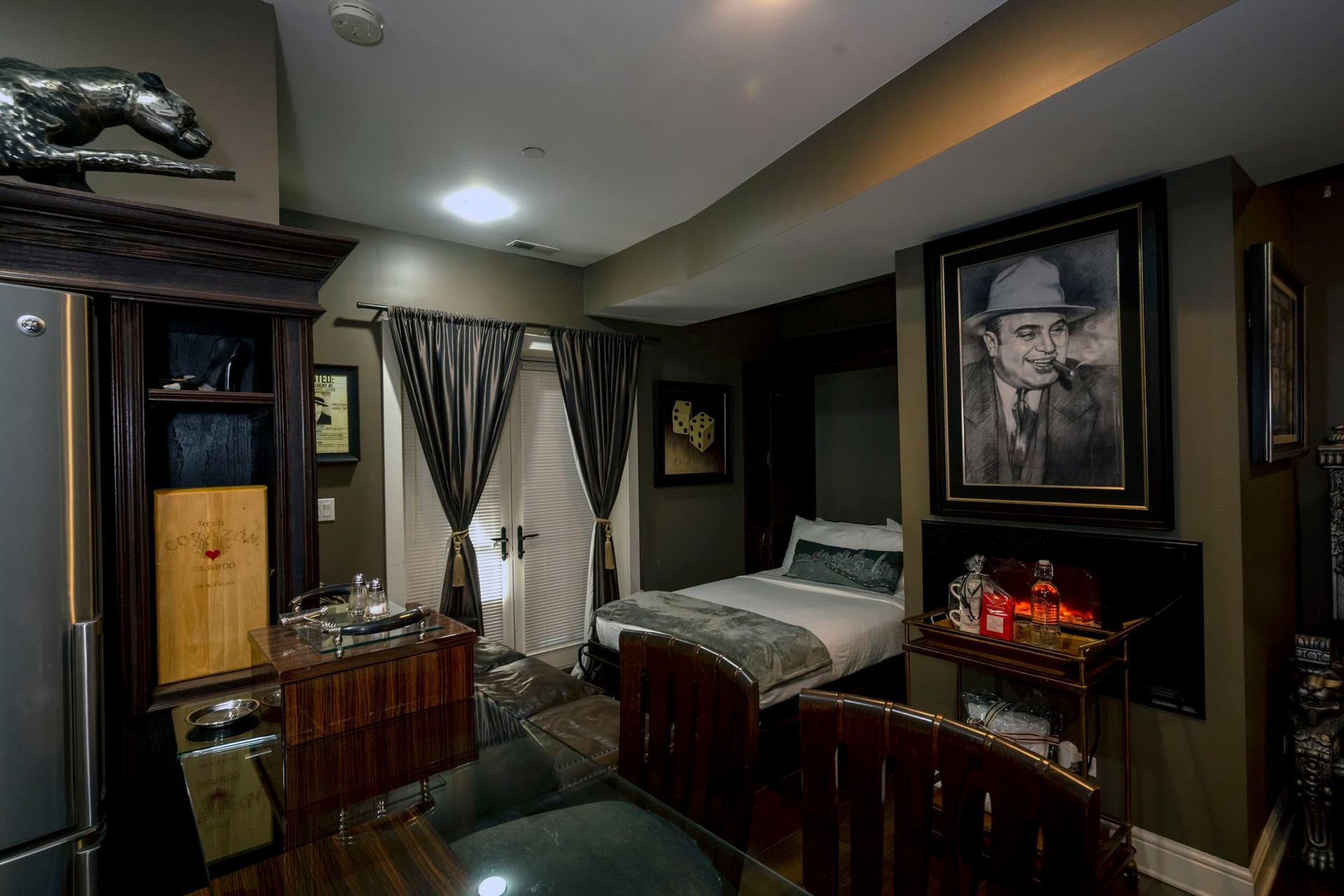 A bedroom with a bed and a painting on the wall