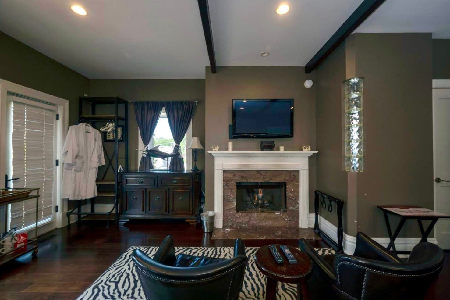 A living room with a fireplace and a flat screen tv