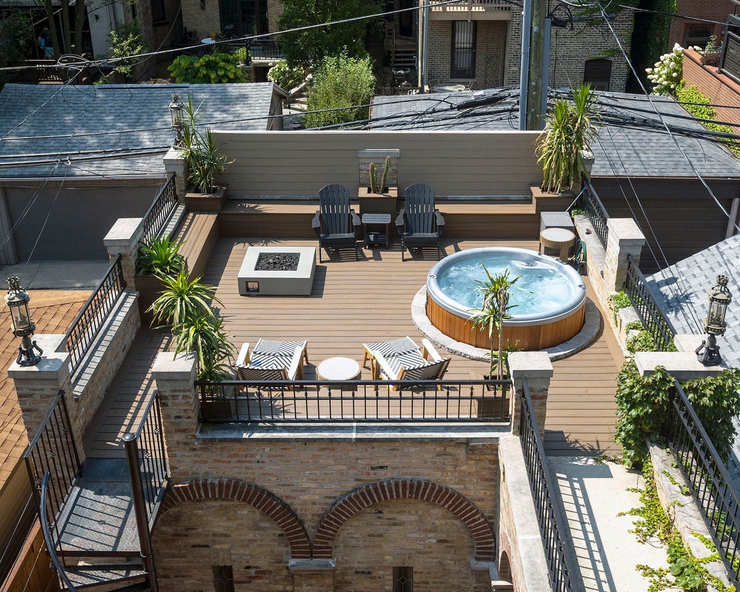 An aerial view of a rooftop deck with a hot tub