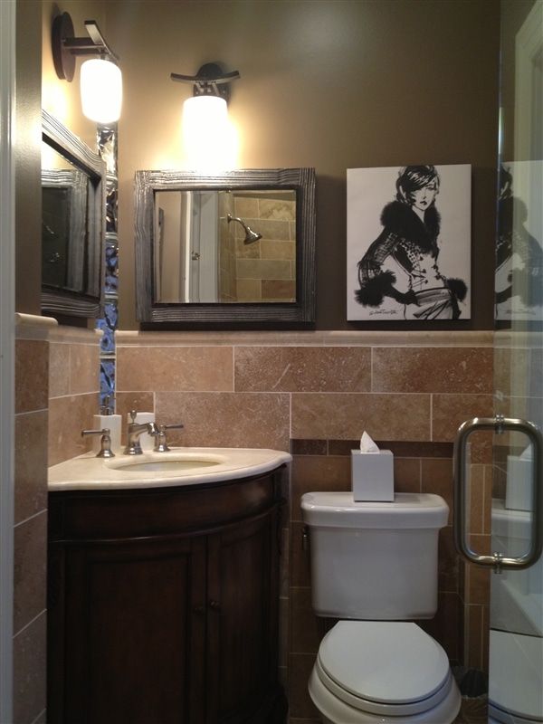 A bathroom with a toilet a sink and a mirror