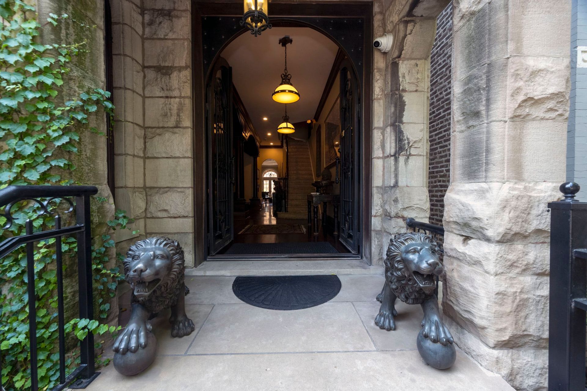 Two statues of lions are in front of a stone building