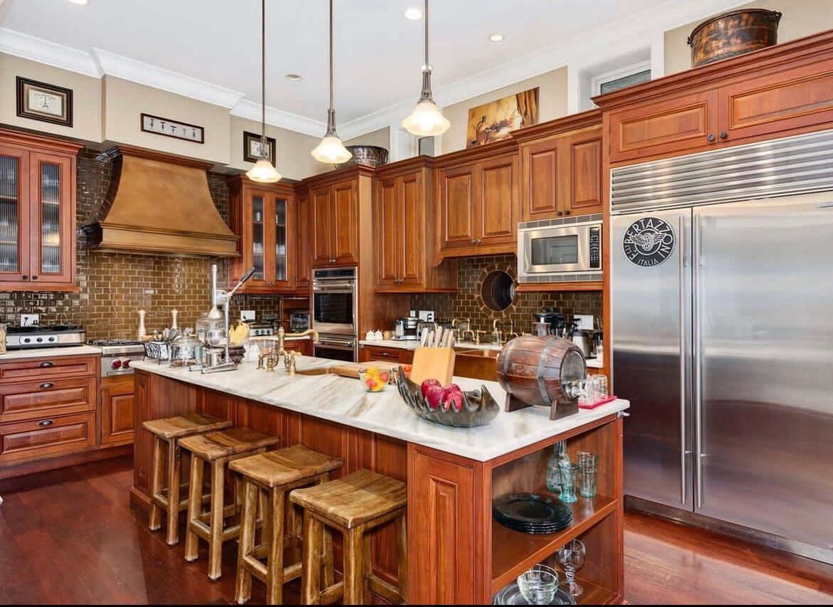 A kitchen with wooden cabinets and stainless steel appliances