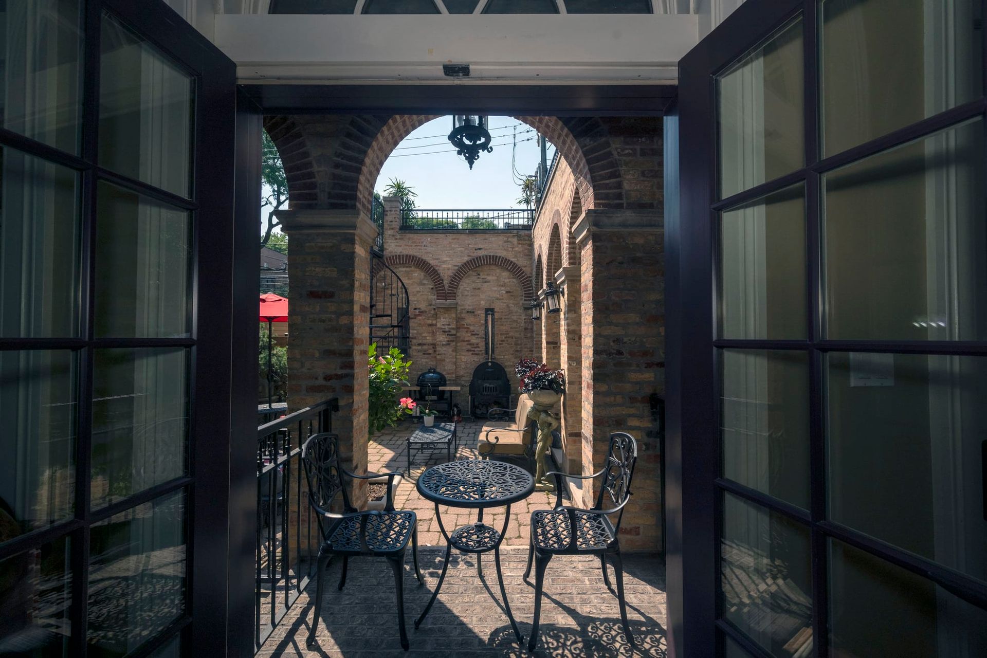 A view of a patio with a table and chairs through a doorway.