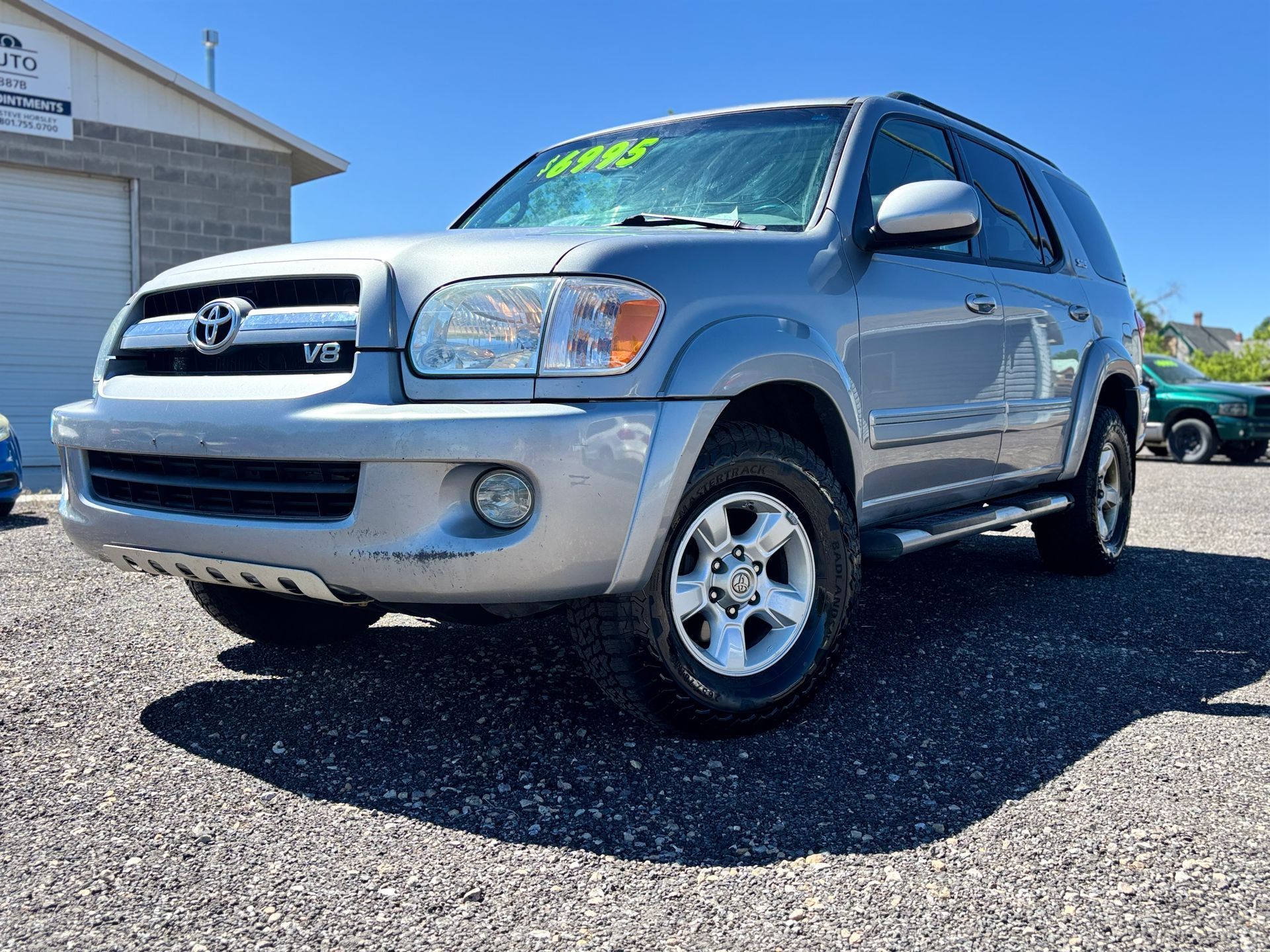 Silver Toyota SUV parked on a sunny lot beside a building