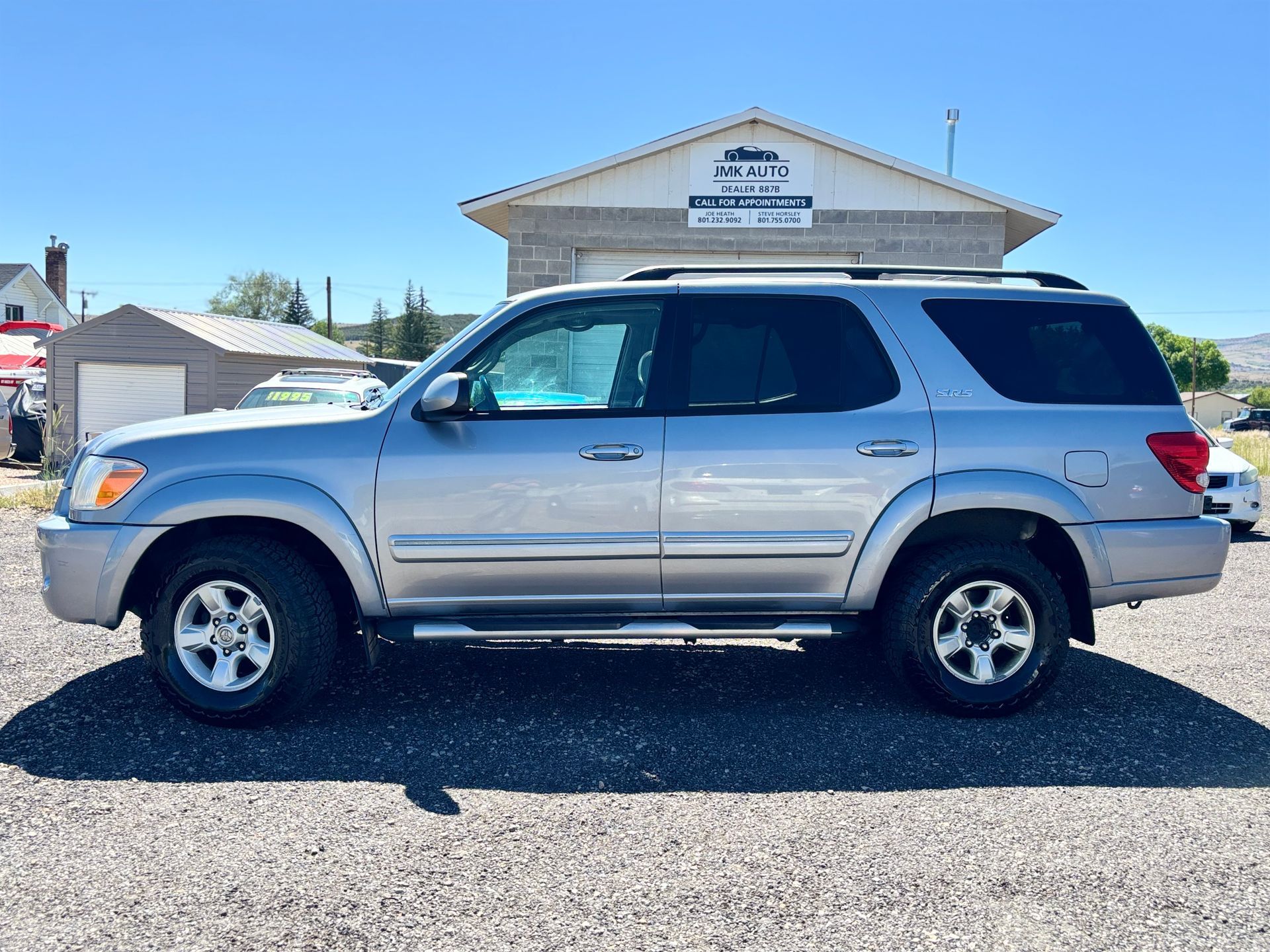 Silver SUV parked in front of a building under a clear blue sky