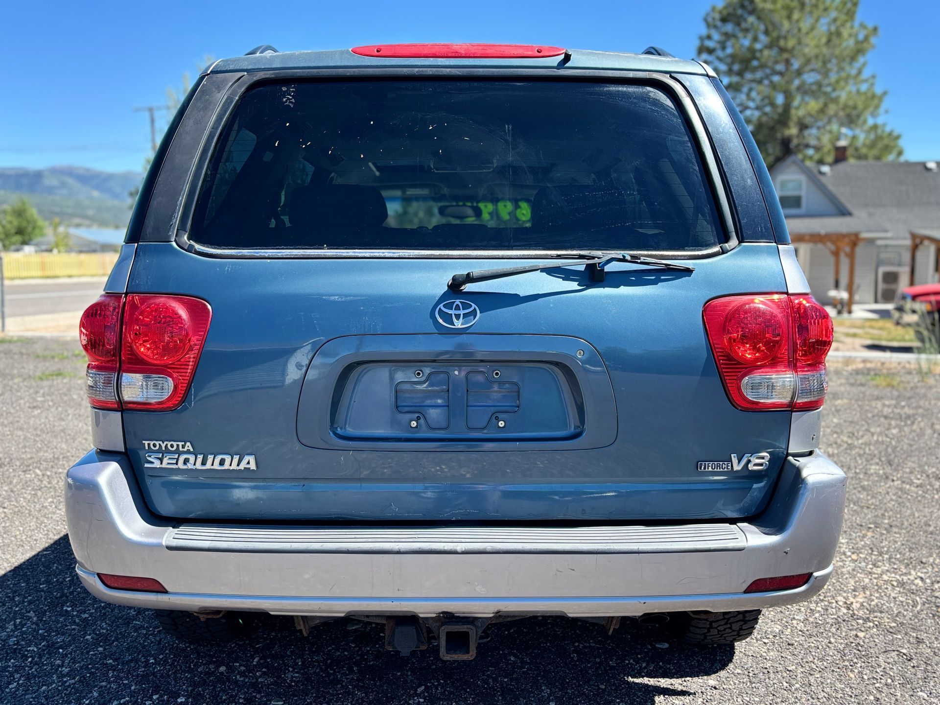 Blue Toyota Tacoma pickup truck seen from the rear in a parking lot
