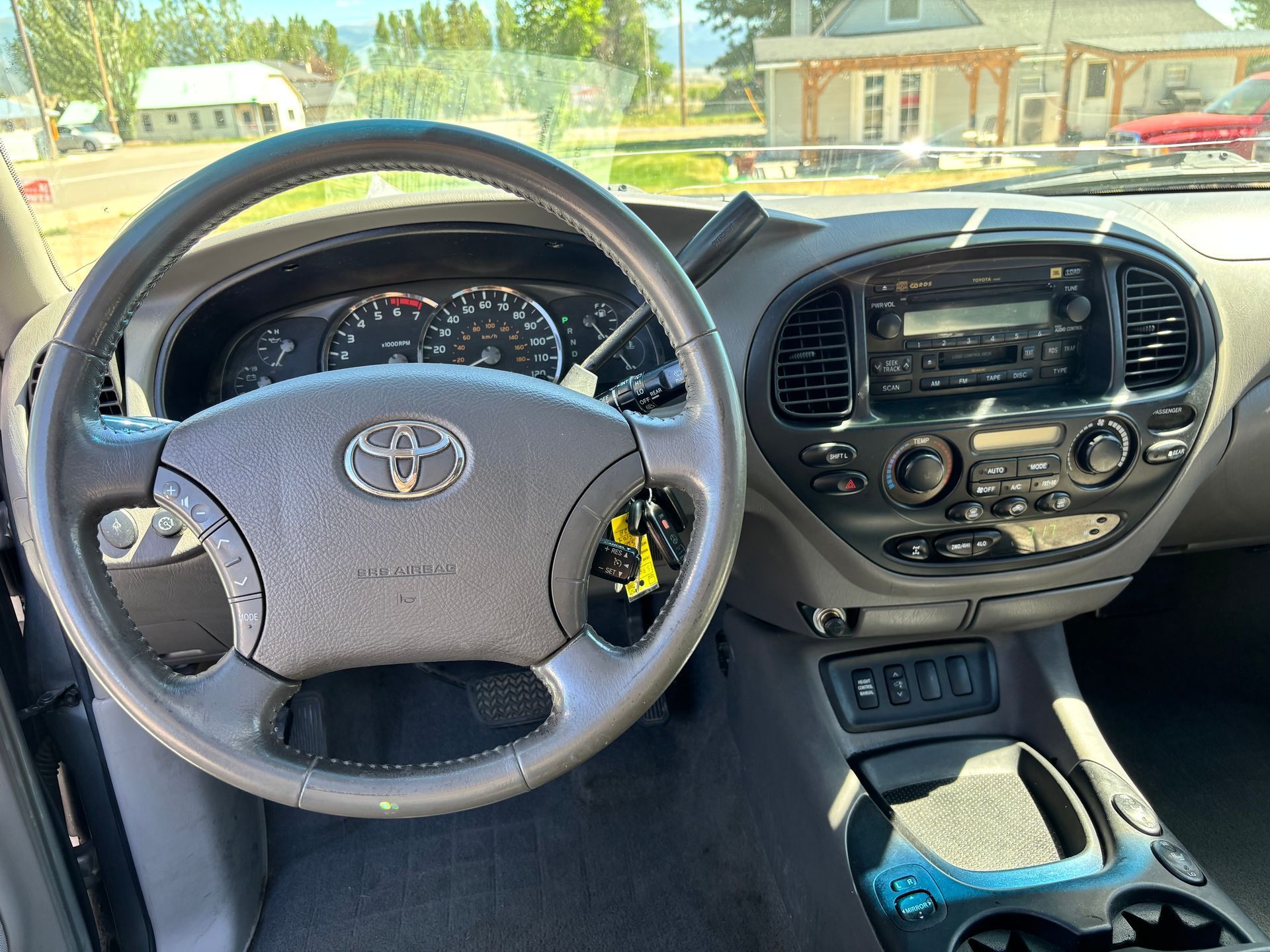 Toyota car interior seen from the driver’s seat, with steering wheel and center console visible.