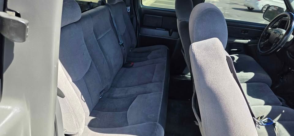 Gray cloth seats in a vehicle interior, showing the back seat and front passenger area.