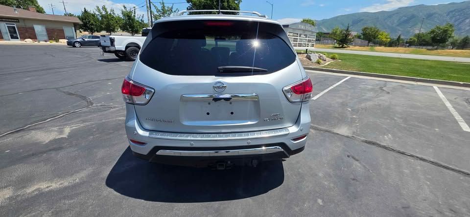 Silver SUV parked in an empty parking lot under bright sun
