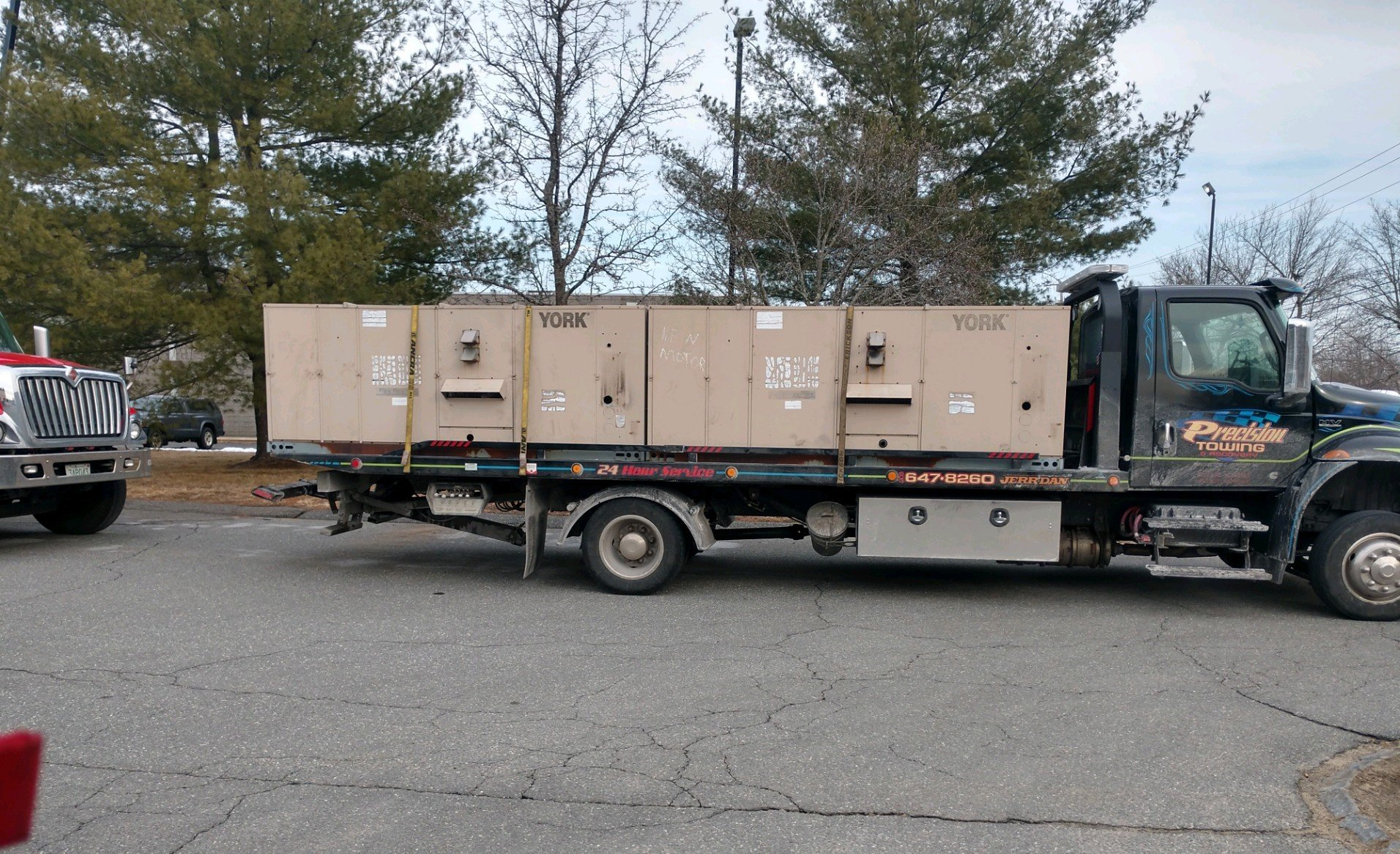 vintage red pickup truck being transported on flatbed
