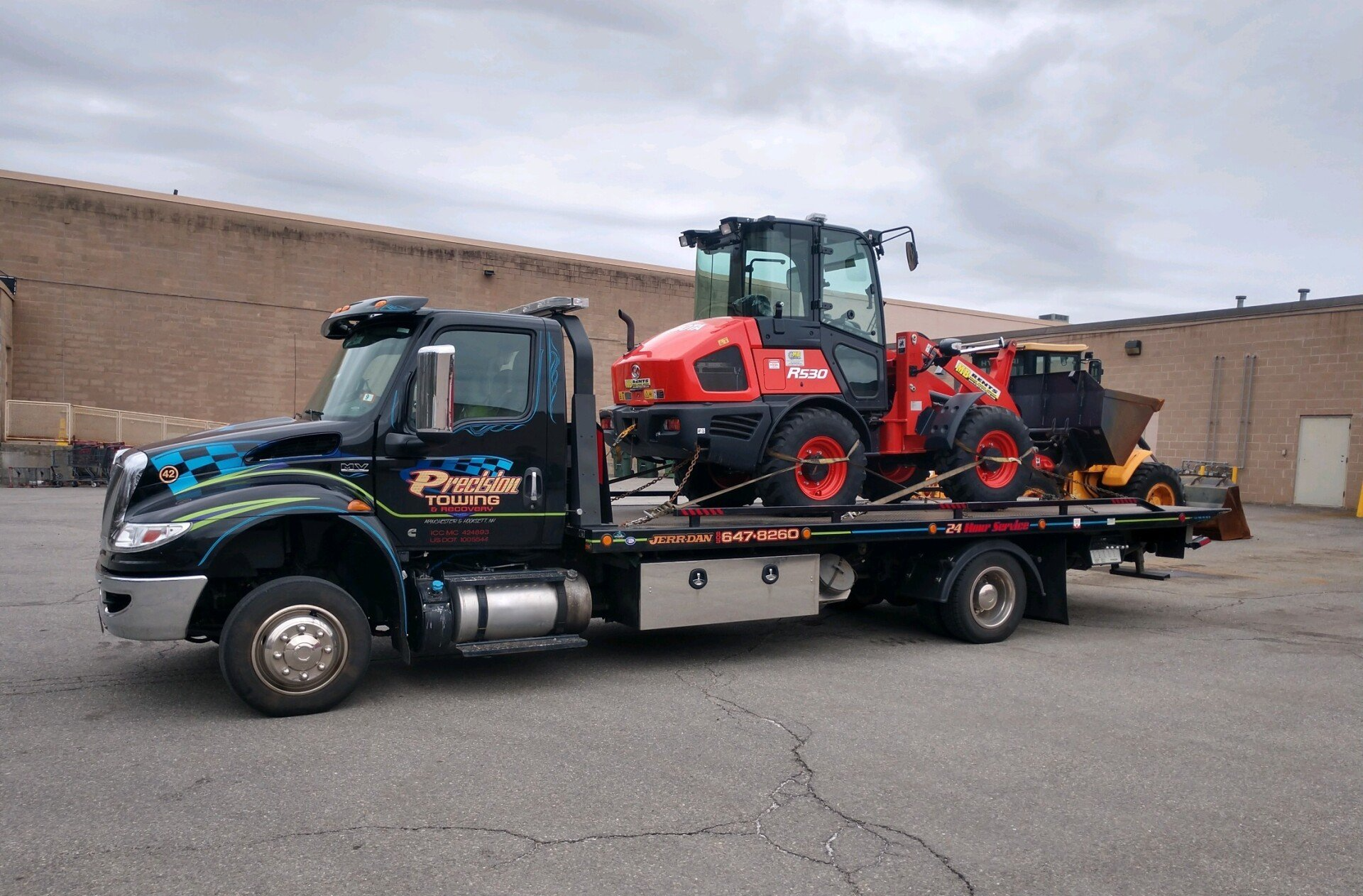 tow truck hauling construction equipment