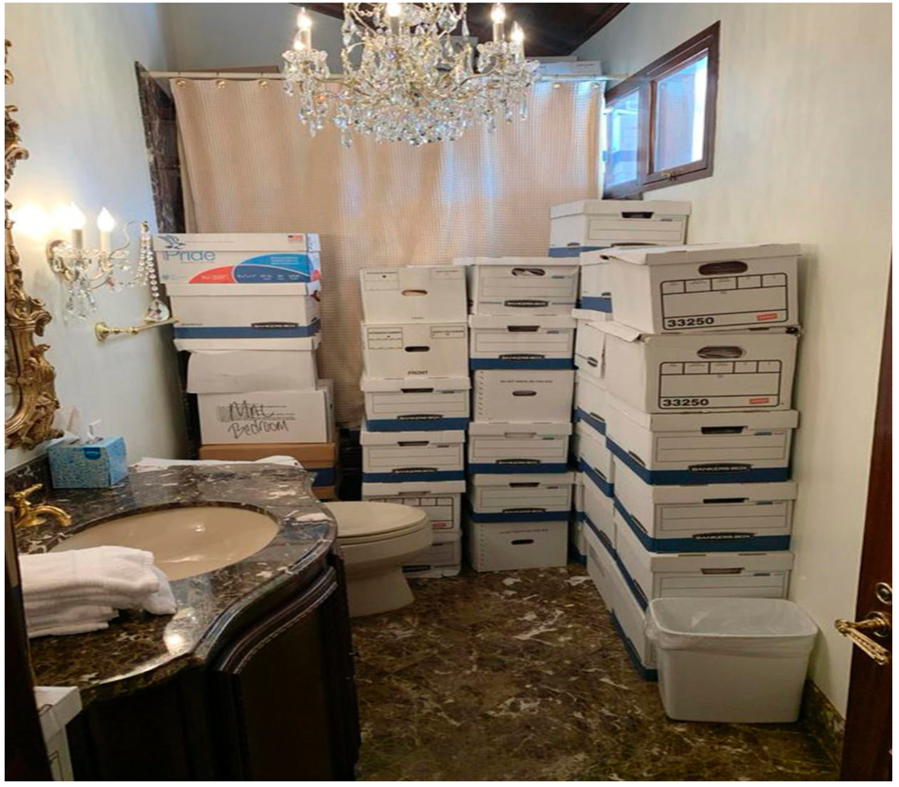 A bathroom filled with boxes and a chandelier