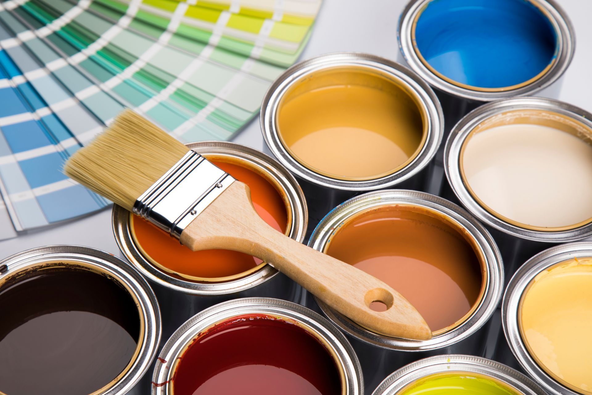 Paint cans with a brush and color swatches showing a paint selection sample