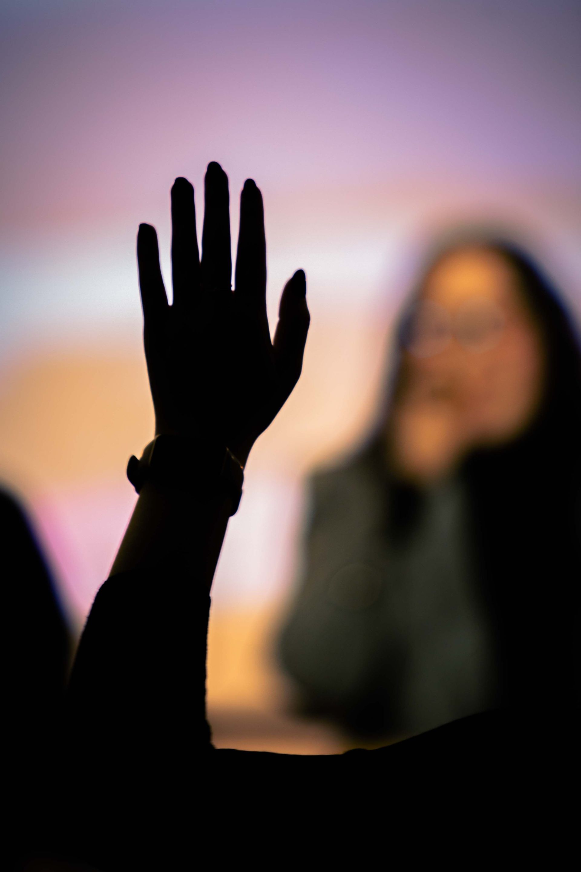 Person raising hand to aska question