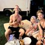 A group of people are sitting around a table eating food.