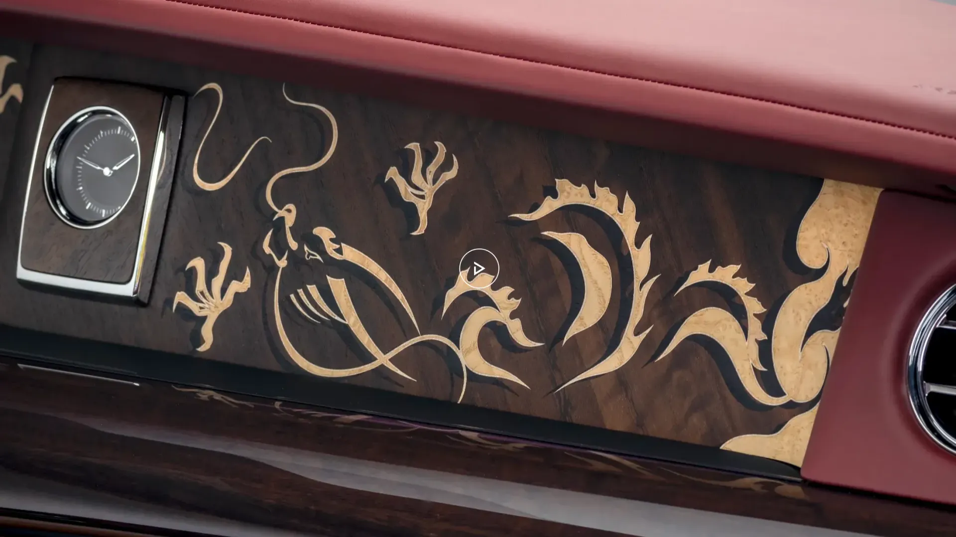 A close up of a car dashboard with a dragon design on it