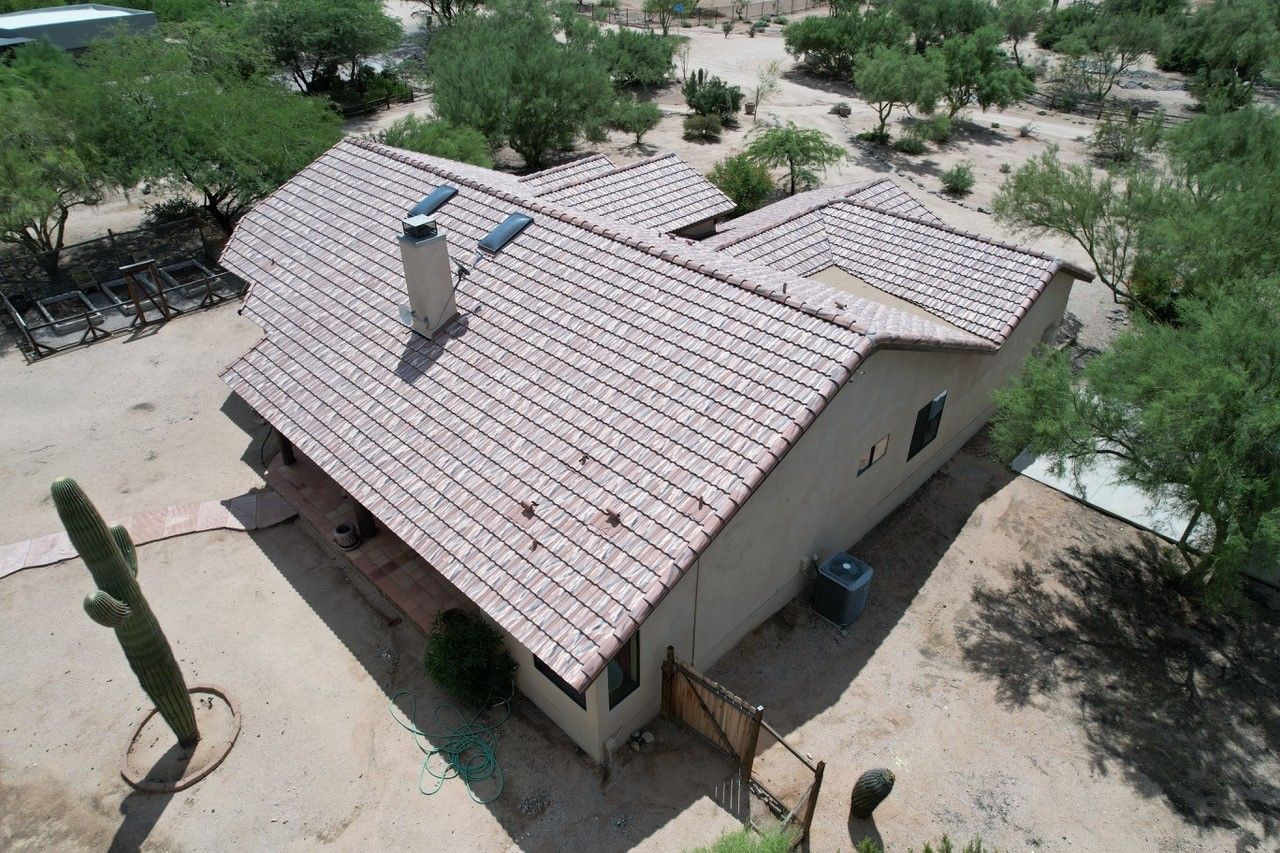 An aerial view of a house with a tiled roof in the desert.