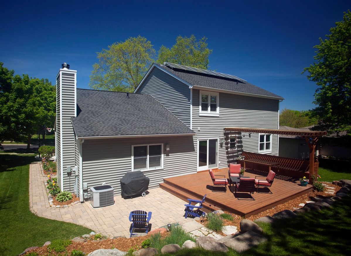 A house with a large deck and patio area in front of it