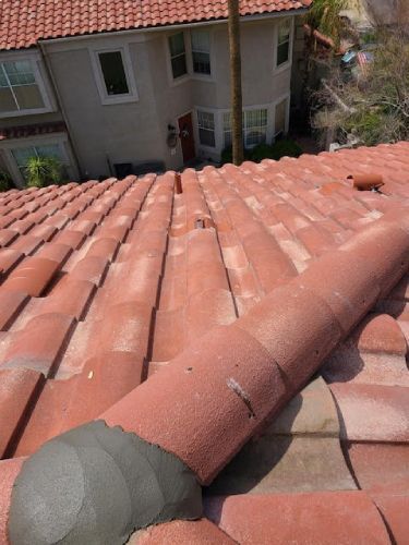 The roof of a house has a lot of tiles on it