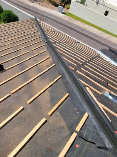 A roof that is being built with wooden beams