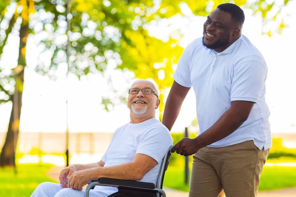 two men - one standing and one in a wheelchair