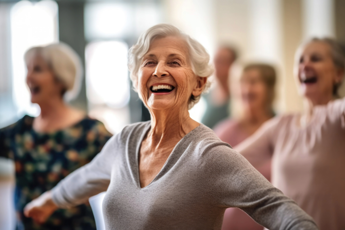 Senior woman smiling while exercising at a Move and Groove Group session