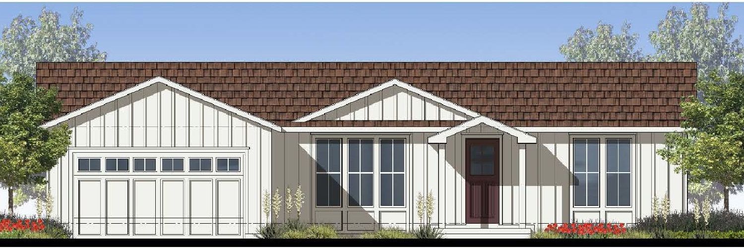 Perpetual Homes ADU: White house with a brown roof and a garage door. Two windows on the side and a front door. 