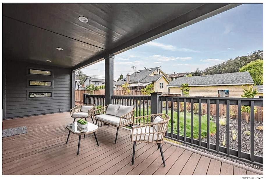 Perpetual Homes ADU covered porch with chairs overlooking a suburban neighborhood and blue sky