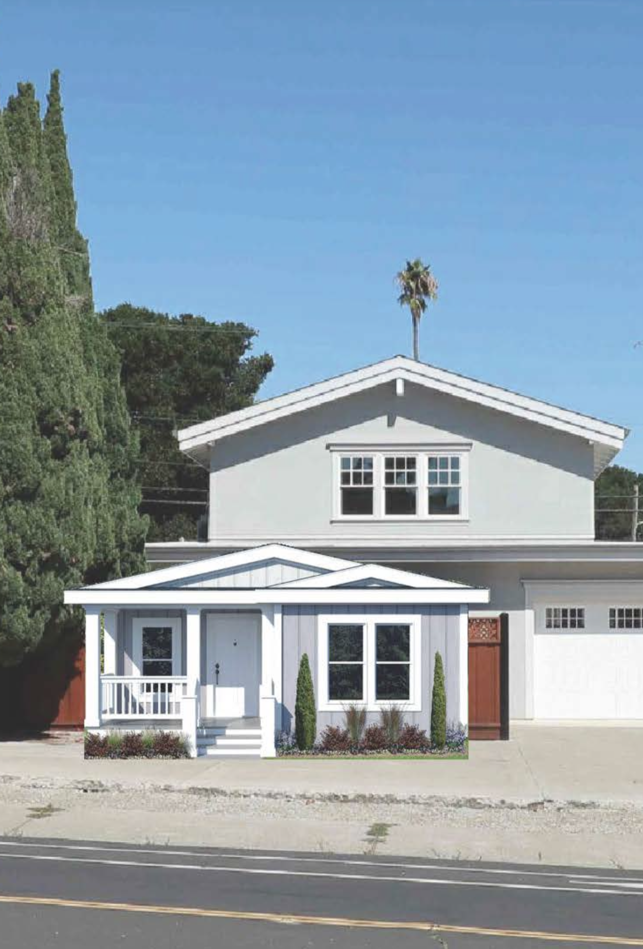 Perpetual Homes ADU: Two-story light blue house with a small porch and light blue siding; a large tree on the left.