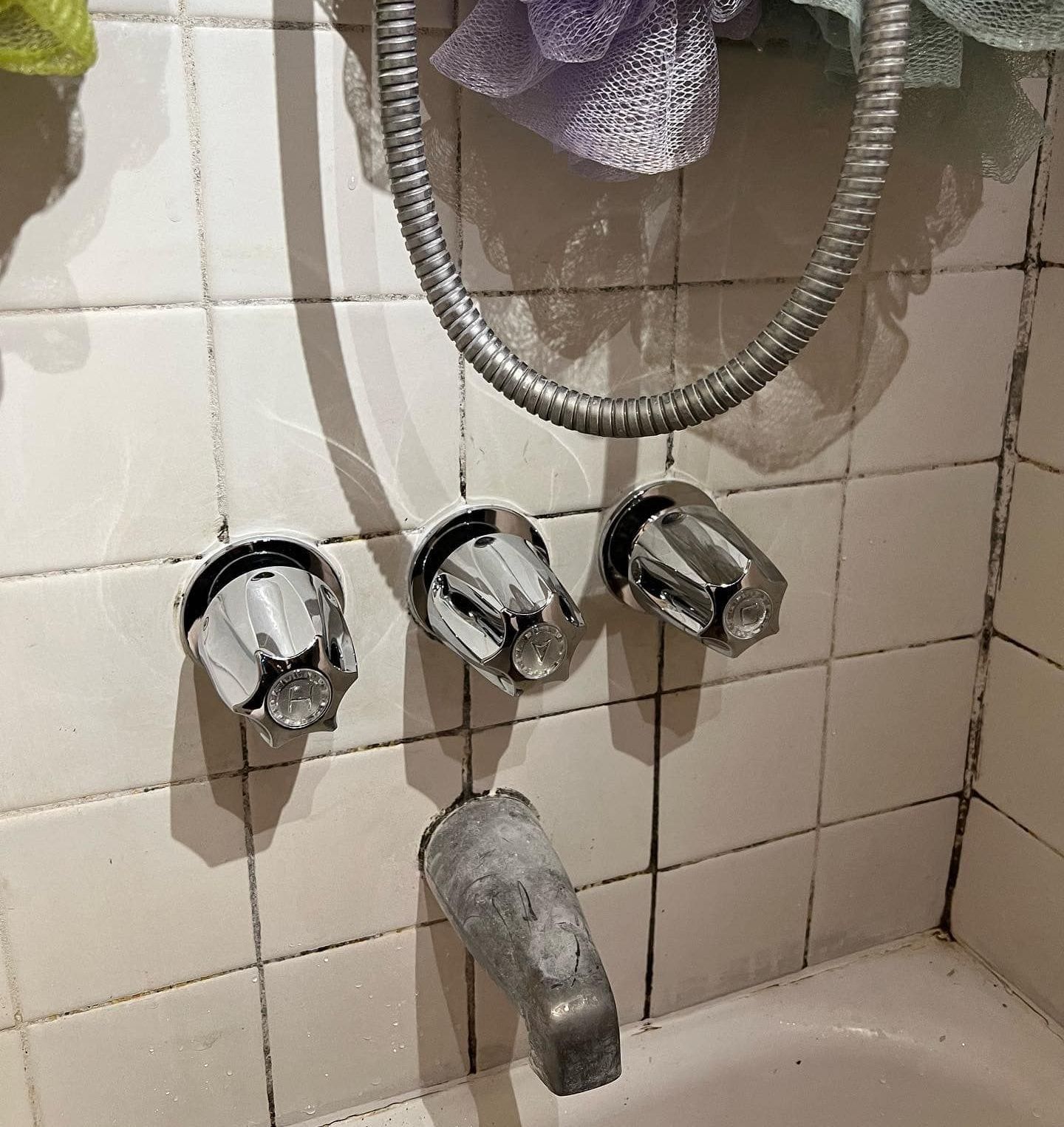 A bathtub with a shower head attached to it